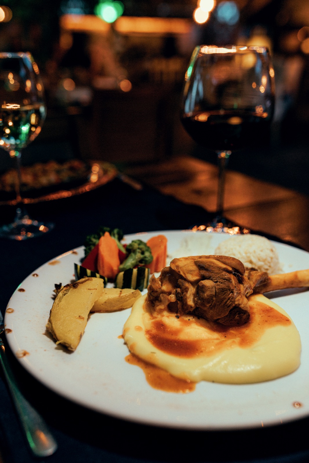 Lamb shank with mashed potato and grilled vegetables