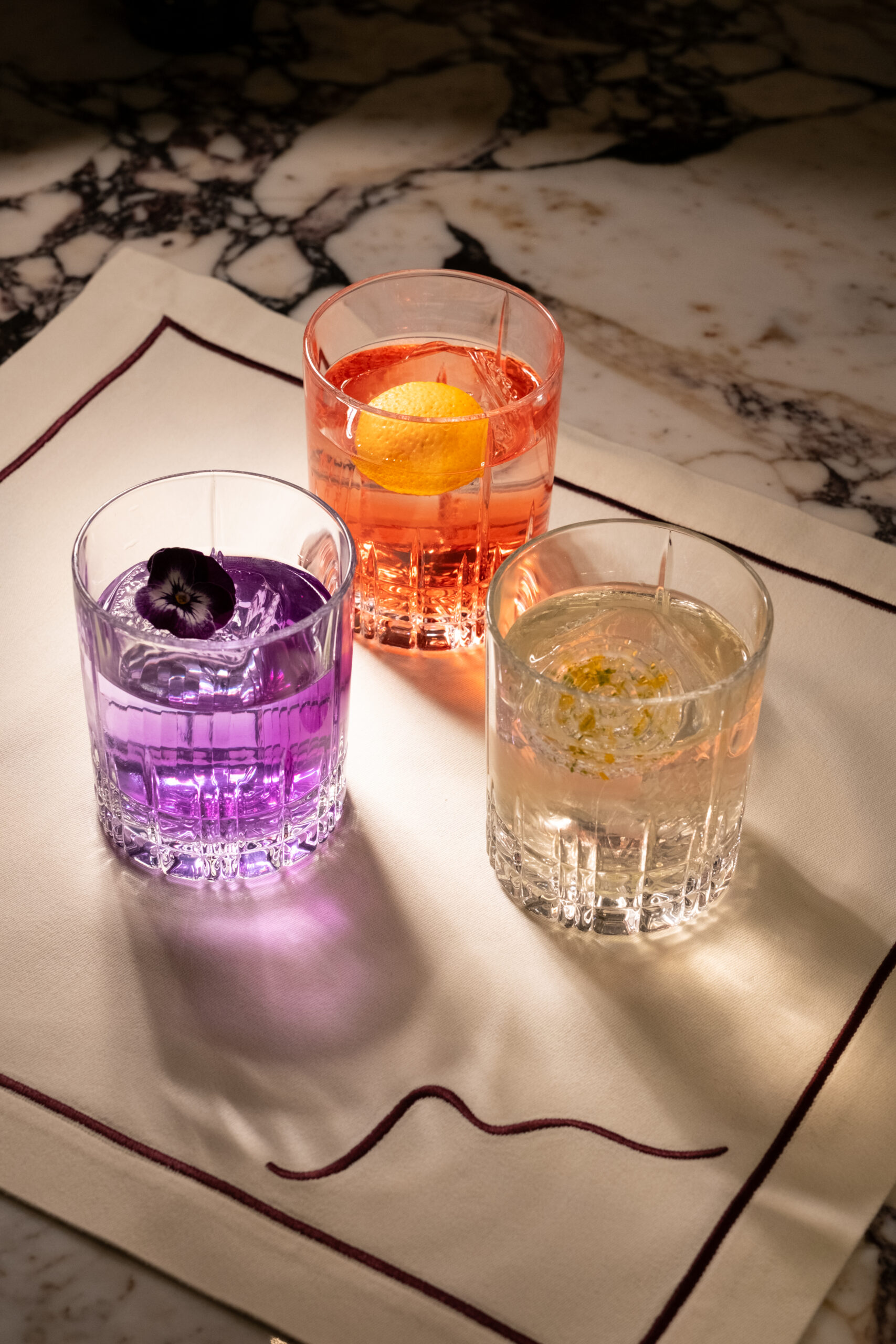 Three signature cocktails on marble